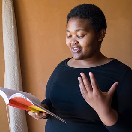 A woman reading poetry to celebrate national poetry month and demonstrate why poetry is important