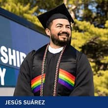 Jesús Suárez, a 2021 graduate of SNHU's Graphic Design program, standing in graduation regalia