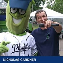 Nicholas Gardner with Portland Pickles mascot, Dillon the Pickle, and the text 'Nicholas Gardner'