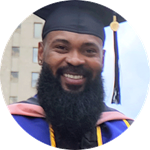 First-generation college student, SNHU graduate and Pennsylvania resident Kemar Reid wearing his cap and gown