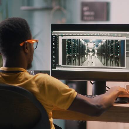 A student discovering what he can do with a 3D animation degree by using design software on a computer.