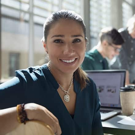 An accounting major smiling at camera while in meeting