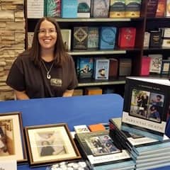 Michelle Shreeve, an SNHU graduate with an MA in English and an MA in Creative Writing, at a book signing being held at a bookstore.