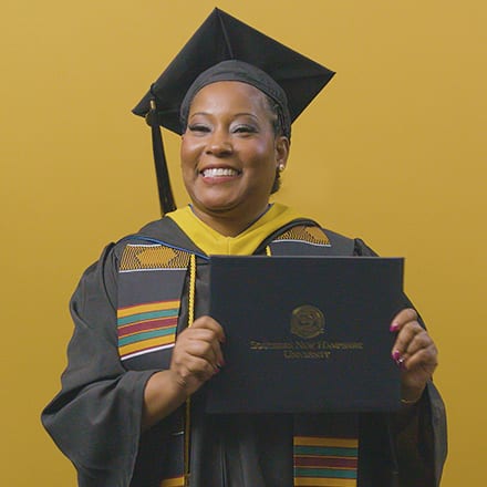 Andrinna Broadnax '25, bachelor's in public health graduate from SNHU, holding her diploma.