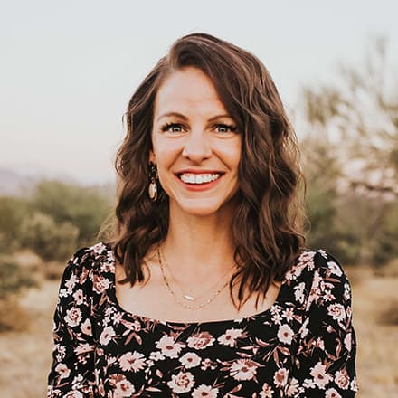 Dr. Ashley Dellosa, an associate business dean at SNHU, wearing a black top with light flowers on it.
