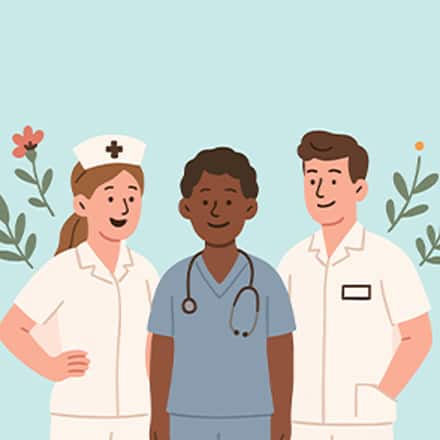 Three smiling nurses, two in white uniforms and one in blue scrubs with a stethoscope, standing together.