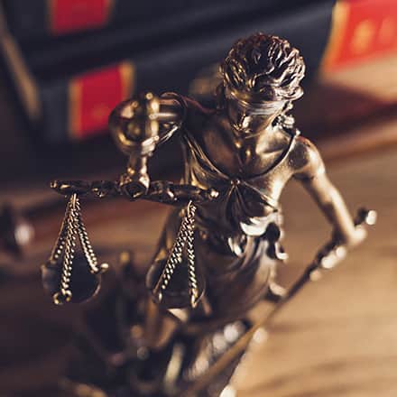 Statue of Lady Justice holding up a set of scales.