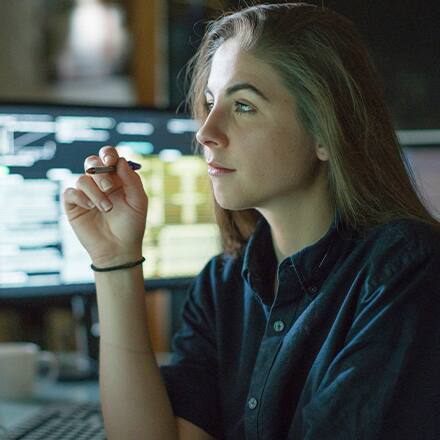 A cybersecurity analyst working on her laptop