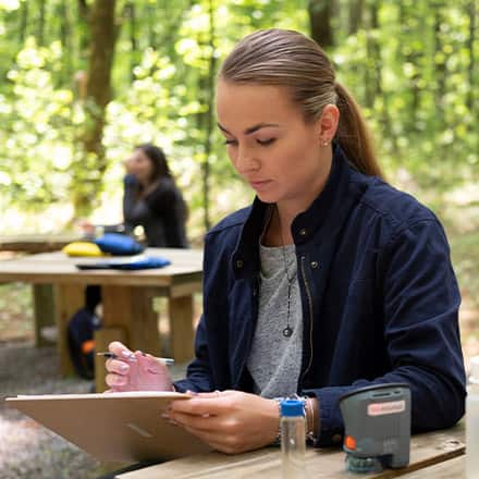 Students working in the field on environmental sustainability practices.