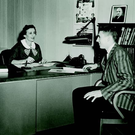 Gertrude Shapiro speaking with a student in her office.