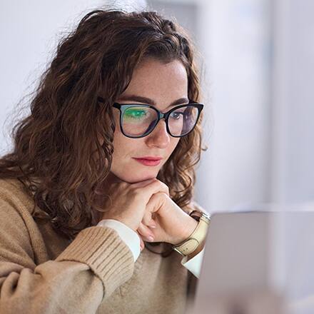 A woman sitting at her laptop reading about different types of research