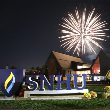 Fireworks above Paul J. LeBlanc Hall and SNHU sign on the university's Manchester, New Hampshire, campus.