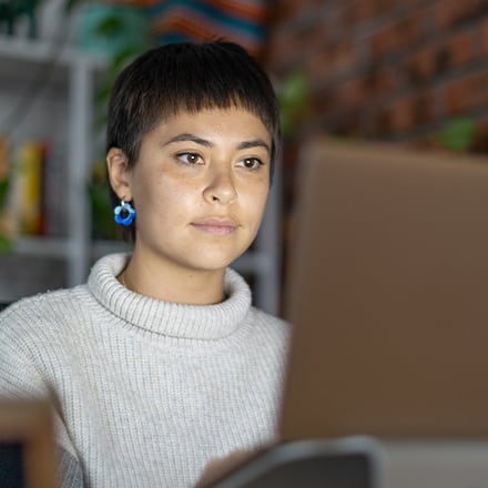A student looking at their laptop researching how long it takes to get an MBA.