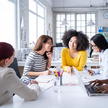 A group of professionals discussing how to become a social media manager.