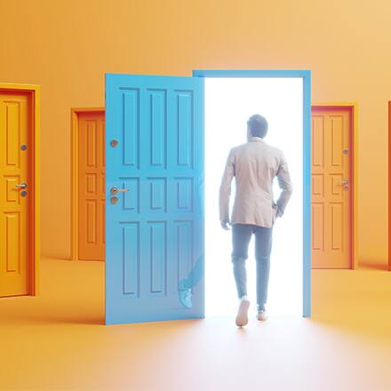 A person walking into an open blue door in a room full of orange doors.