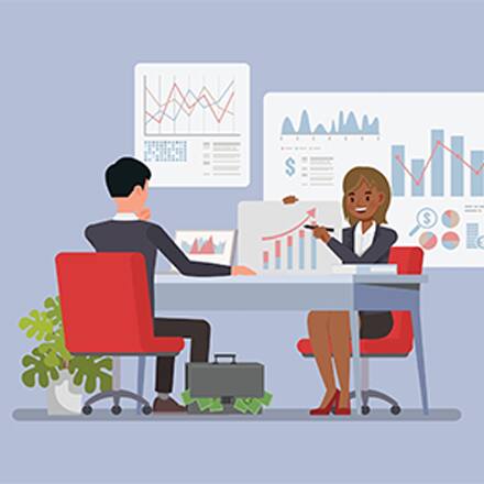 An illustration of a financial advisor sitting at a desk, showing her client several charts.