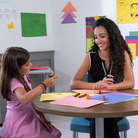 A professional with a child psychology degree working with a child.