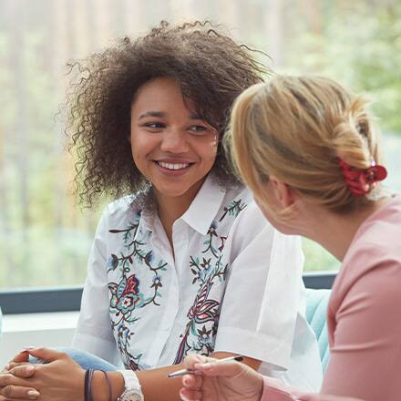 A student talking to a professional about how to become a social worker.