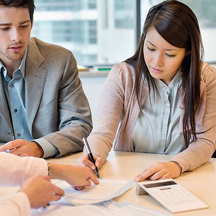 A woman with her master's in accounting working with clients in her office.