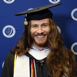 Lawrence Michael Mazza II in a graduation cap and gown at his SNHU Commencement ceremony.