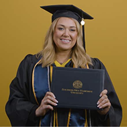 Madison Richards dressed in a graduation cap and gown after earning her bachelor's in marketing with a concentration in digital marketing at SNHU in 2026.