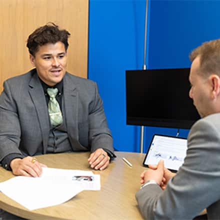 Kevin Bucardo, MBA with a concentration in Finance graduate from SNHU, engaged at work.