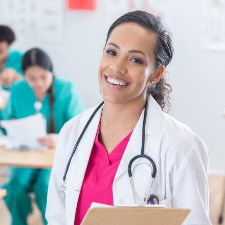 A person with a stethoscope and clipboard who gets to be both a nurse and a teacher as a nurse educator.