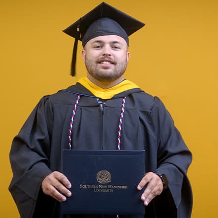 Payton Good, a 2025 SNHU graduate who earned his bachelor's in operations management wearing his cap and gown in front of a yellow background. 