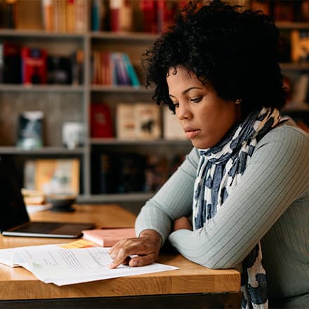 A student studying her textbook as she pursues a master's degree