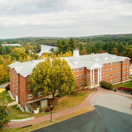 Washington Hall on Southern New Hampshire University’s Manchester campus, surrounded by trees.