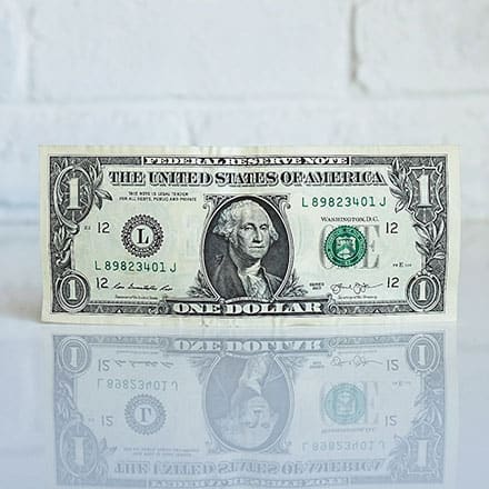 Picture of a dollar bill and its reflection beneath it