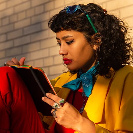 A pen resting on a pad of paper listing a series of SMART goals.