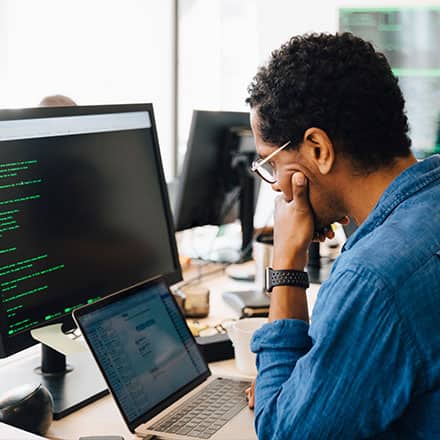A professional in a cyber security role, working on computer.