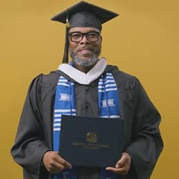 Tyrone R. Turner-Perry, an SNHU graduate with a bachelor's in communication, dressed in his graduation cap and gown.