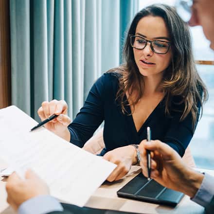 A woman showing someone a look into what a bookkeeper does