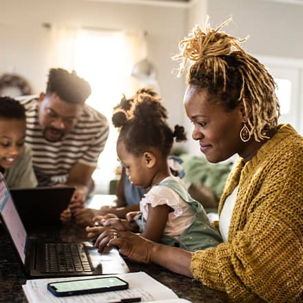 A woman surrounded by family researching what a general studies degree is 