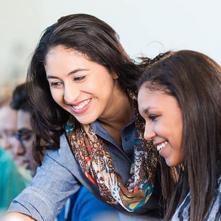 An educator earning her MEd and helping a student.