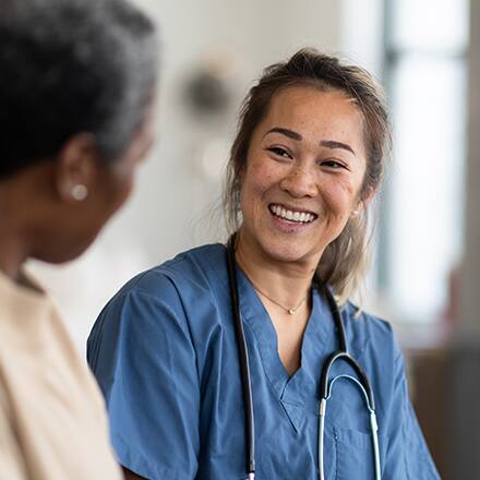 A nurse smiles and explains to another nurse what is an MSN degree