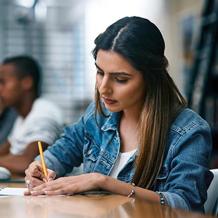 A young woman filling out a student loan application.