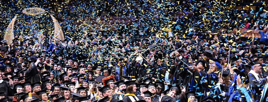 Confetti floating above graduates at SNHU's 2025 Fall Commencement.