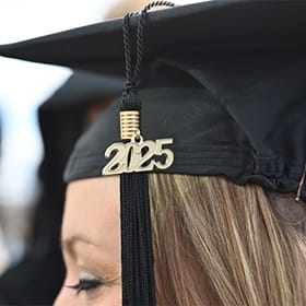 A close up image of an SNHU graduate's cap with a gold 2025 hanging from the tassel.