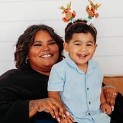 Biancca Martinez, pursuing a bachelor's in health science at SNHU sitting with her son.