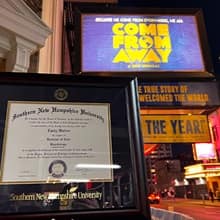 Emily Walton’s SNHU diploma next to a “Come From Away” sign.