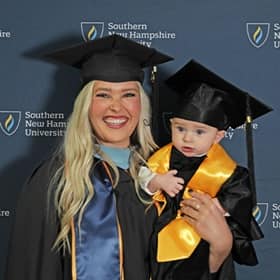 Casey Rasmussen, a 2023 SNHU Master of Education graduate, holding son Rockwell