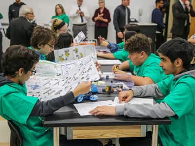 Students at Madeline English School assembling robots at the schools new technology lab. 