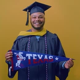 Cules Rose '25, bachelor's in finance graduate from SNHU holding a Texas state pennant.