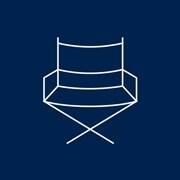 A blue and white icon of a director's chair