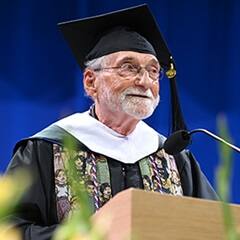 Donald John Mossa, a 2026 SNHU graduate with a master's in clinical mental health counseling, speaking at his commencement ceremony.