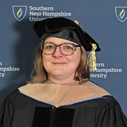 SNHU Associate Dean of Business Dr. Zuzana Buzzell wearing her cap and gown at a Commencement ceremony.