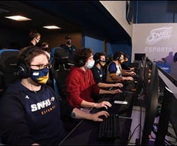 A group of snhu esports player competing in a competition 